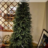 D103. Pre-lit faux Christmas tree with metal base. 46”h - $34